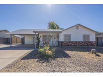 Charming single-story home with a covered front porch and low-maintenance desert landscaping at 643 N 92Nd Pl, Mesa, AZ 85207