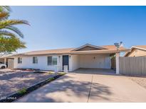 Charming single-story home with a carport, brick accents, desert landscaping and a tidy front yard at 656 E Mesquite Ave, Apache Junction, AZ 85119
