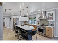Spacious kitchen features a large island with seating, stainless steel appliances, and designer backsplash at 7202 N 16Th Dr, Phoenix, AZ 85021