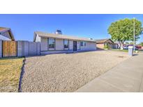 Charming single-story home featuring low-maintenance gravel landscaping and a well-kept facade at 7332 W Desert Cove Ave, Peoria, AZ 85345