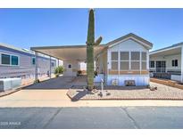 Charming single-story home with carport and mature saguaro cactus in the front yard at 111 S Greenfield Rd # 405, Mesa, AZ 85206