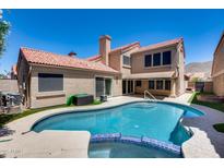 Backyard oasis features a sparkling pool with blue tile accents and a covered patio for relaxing in the shade at 11217 E Laurel Ln, Scottsdale, AZ 85259