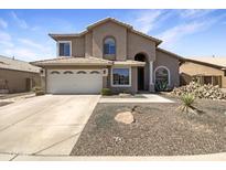 Beautiful two-story home featuring a two car garage and low maintenance desert landscaping in front yard at 11534 E Downing St, Mesa, AZ 85207