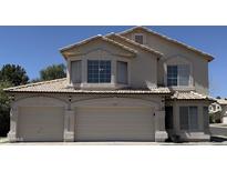 Inviting two-story home featuring a three-car garage and well-maintained landscaping at 1212 W Glenmere Dr, Chandler, AZ 85224