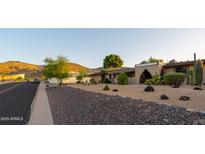 Single story home with low-water landscaping, desert plants, and an arched entryway at 13034 N 8Th Ave, Phoenix, AZ 85029
