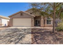 Charming single-story home featuring a two-car garage and low-maintenance landscaping at 1619 E Aspen Ave, Buckeye, AZ 85326