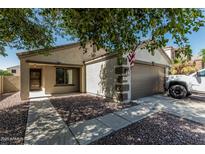 Charming single-story home featuring a well-maintained front yard and attached two-car garage at 17611 W Watson Ln, Surprise, AZ 85388