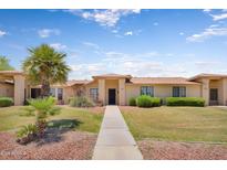 Charming single-story home with mature palm trees and well-maintained landscaping at 18416 N Spanish Garden Dr, Sun City West, AZ 85375