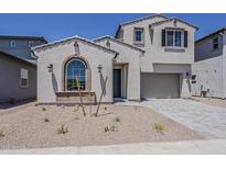 Two-story home features neutral stucco, tiled roof, arched window, and two-car garage with a paved driveway at 21276 W Mariposa St, Buckeye, AZ 85396
