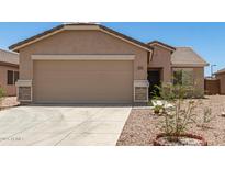 Charming single-story home with a two-car garage and low-maintenance desert landscaping at 22547 W Pima St, Buckeye, AZ 85326