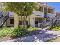 Charming condo building with stairs, stucco exterior, and lush green landscaping at 2333 E Southern Ave # 1023, Tempe, AZ 85282