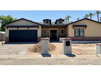 Charming single-Gathering home with a garage and unique architectural details under a clear blue sky at 3028 N 47Th St, Phoenix, AZ 85018