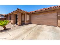 Charming single-story home featuring a terracotta roof, desert landscaping, and an attached two-car garage at 3438 S Bowman Rd, Apache Junction, AZ 85119