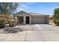 Charming single-story home with a well-maintained front yard and a two car attached garage at 5026 S 235Th Dr, Buckeye, AZ 85326