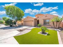 Charming single-story home featuring a well-manicured lawn, desert landscaping, and a two-car garage in a desirable location at 5123 W Redbird Rd, Phoenix, AZ 85083