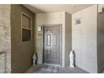 Inviting condo front door with welcome mat and charming decorative statues on either side at 5303 N 7Th St # 331, Phoenix, AZ 85014