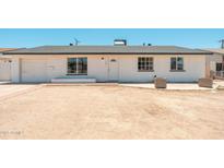 Welcoming exterior view of a single-story home featuring a freshly painted white facade and a desert landscape at 6223 W Earll Dr, Phoenix, AZ 85033
