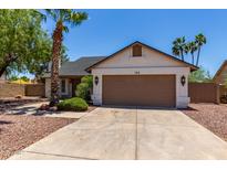 Charming single-story home with a well-maintained lawn, mature trees, and a two-car garage at 723 E Piute Ave, Phoenix, AZ 85024