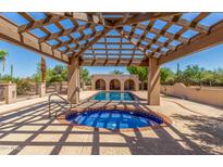 Stunning pool and spa area featuring a covered patio with wood beams and blue tile accents at 8043 E Laurel St, Mesa, AZ 85207