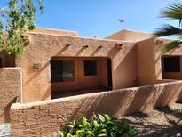 Exterior of home featuring stucco walls, desert landscaping and partially covered patio at 8940 W Olive Ave # 39, Peoria, AZ 85345