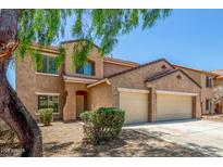 Charming two-story home featuring a two-car garage and well-maintained landscaping, perfect for Gathering living at 11871 W Sherman St, Avondale, AZ 85323