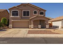 Two-story home featuring a covered porch, low maintenance front yard, and an attached two-car garage at 12720 W Cantenia Rd, Avondale, AZ 85392