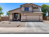 Charming two-story home showcasing a well-maintained front yard and inviting facade under a clear blue sky at 1359 E 12Th St, Casa Grande, AZ 85122