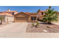 Charming single-story home with a two-car garage and desert landscaping in a residential neighborhood at 1534 E Mineral Rd, Gilbert, AZ 85234