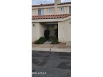 Charming townhome exterior with a tile roof and desert landscaping leading to the front door at 16021 N 30Th St # 113, Phoenix, AZ 85032