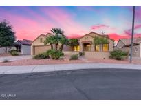 Charming single-story home featuring desert landscaping and a private gated courtyard entrance at 17911 N Adobe Mesa Ct, Surprise, AZ 85374