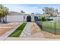 Charming single-story home featuring an attached garage and manicured front yard with fresh turf accents at 2106 W 8Th Ave, Mesa, AZ 85202