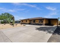 Single story home featuring a low maintenance desert landscape, covered parking, and stone accents at 2118 W Cactus Wren Dr, Phoenix, AZ 85021