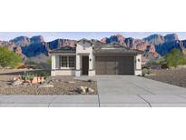 Charming single-Gathering home with a two-car garage, desert landscaping, and mountain views at 24214 W Hacienda Ave, Buckeye, AZ 85326