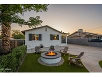 Charming home showcasing a cozy fire pit with Adirondack chairs on artificial grass at 2520 N 15Th St, Phoenix, AZ 85006