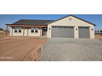 Beautiful single-story home featuring a spacious two-car garage and charming covered entry at 28151 N Faded Creek Dr, Florence, AZ 85132