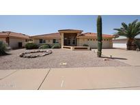 Inviting single-story home with desert landscaping, a tile roof, and an attached two-car garage at 8303 E Monterey Ave, Mesa, AZ 85209