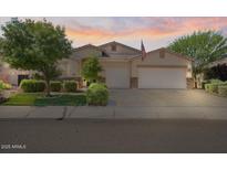Charming single-story home with a well-manicured lawn, mature trees and a three car garage at 1145 E Winchester Pl, Chandler, AZ 85286