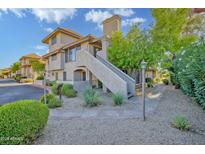 Charming multi-level condo with stucco siding, red tile roof, and well maintained desert landscaping at 1211 N Miller Rd # 257, Scottsdale, AZ 85257