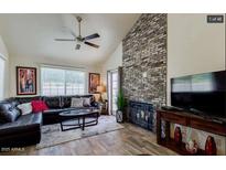 Inviting living room with vaulted ceilings and a striking brick fireplace feature wall at 1222 W Baseline Rd # 163, Tempe, AZ 85283