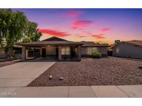 Inviting single-story home featuring a large covered parking area and low maintenance desert landscaping at 137 W Wagoner Rd, Phoenix, AZ 85023