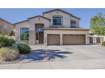Inviting two-story home with a three car garage and meticulously maintained landscaping at 1441 E Folley Pl, Chandler, AZ 85225