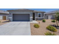 Charming single-story home featuring a two-car garage and low-maintenance desert landscaping at 1560 E Squire Dr, Casa Grande, AZ 85122