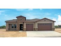 Charming home showcases a stone facade accent, dual-car garage, and desert landscaping at 16777 W Sheila Ln, Goodyear, AZ 85395