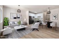 Modern living room showcases an open floorplan to kitchen, dining area, light gray sofa, wood floors, and stylish decor at 1718 W Colter St # 142, Phoenix, AZ 85015