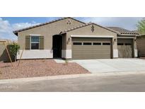 Charming single-story home with a two-car garage and desert landscaping at 20795 N Roadrunner Ln, Maricopa, AZ 85138