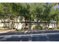 Inviting townhome featuring mature landscaping and a charming facade at 235 W Portland St, Phoenix, AZ 85003