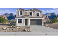 Charming two-story home featuring a gray exterior, gray roof, desert landscaping, and mountain views at 24205 W Southgate Ave, Buckeye, AZ 85326