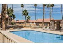 Resort-style pool with palm trees and poolside seating in a well-maintained community setting with desert landscaping at 3511 E Baseline Rd # 1098, Phoenix, AZ 85042