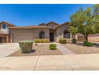 Charming single-story home featuring low maintenance desert landscaping and a two-car garage at 43502 W Kramer Ln, Maricopa, AZ 85138