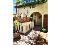 Inviting arched front entrance with a secure decorative gate and privacy fence at 5136 E Evergreen St # 1053, Mesa, AZ 85205